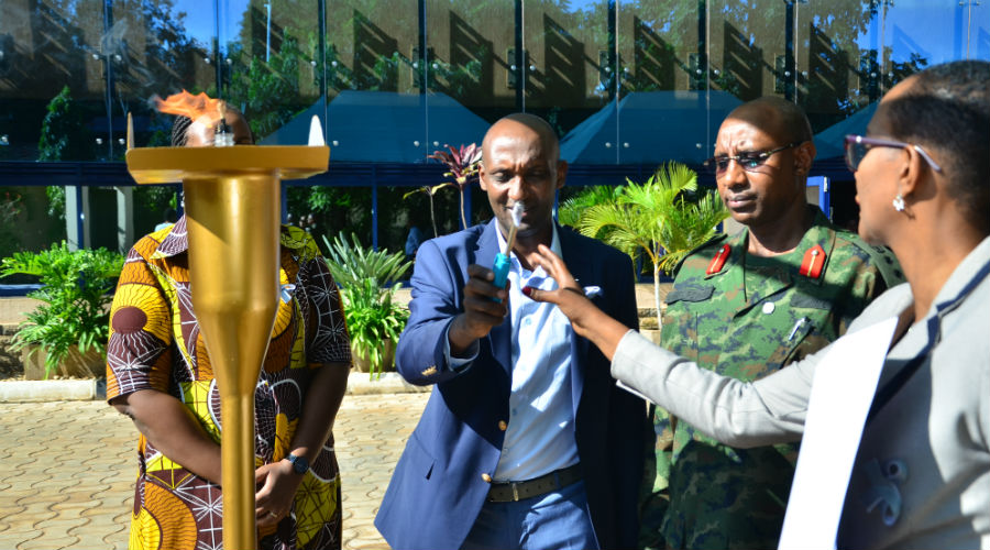 Richard Tusabe the Director General of Rwanda Social Security Board lighting the flame to remember those who lost their lives during the Genocide. / Simon Peter Kaliisa