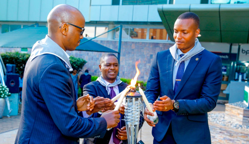 Officials light a candle of hope as BRD kept a vigil in honour of its former employees and clients who were killed during the 1994 Genocide against the Tutsi. Courtesy.