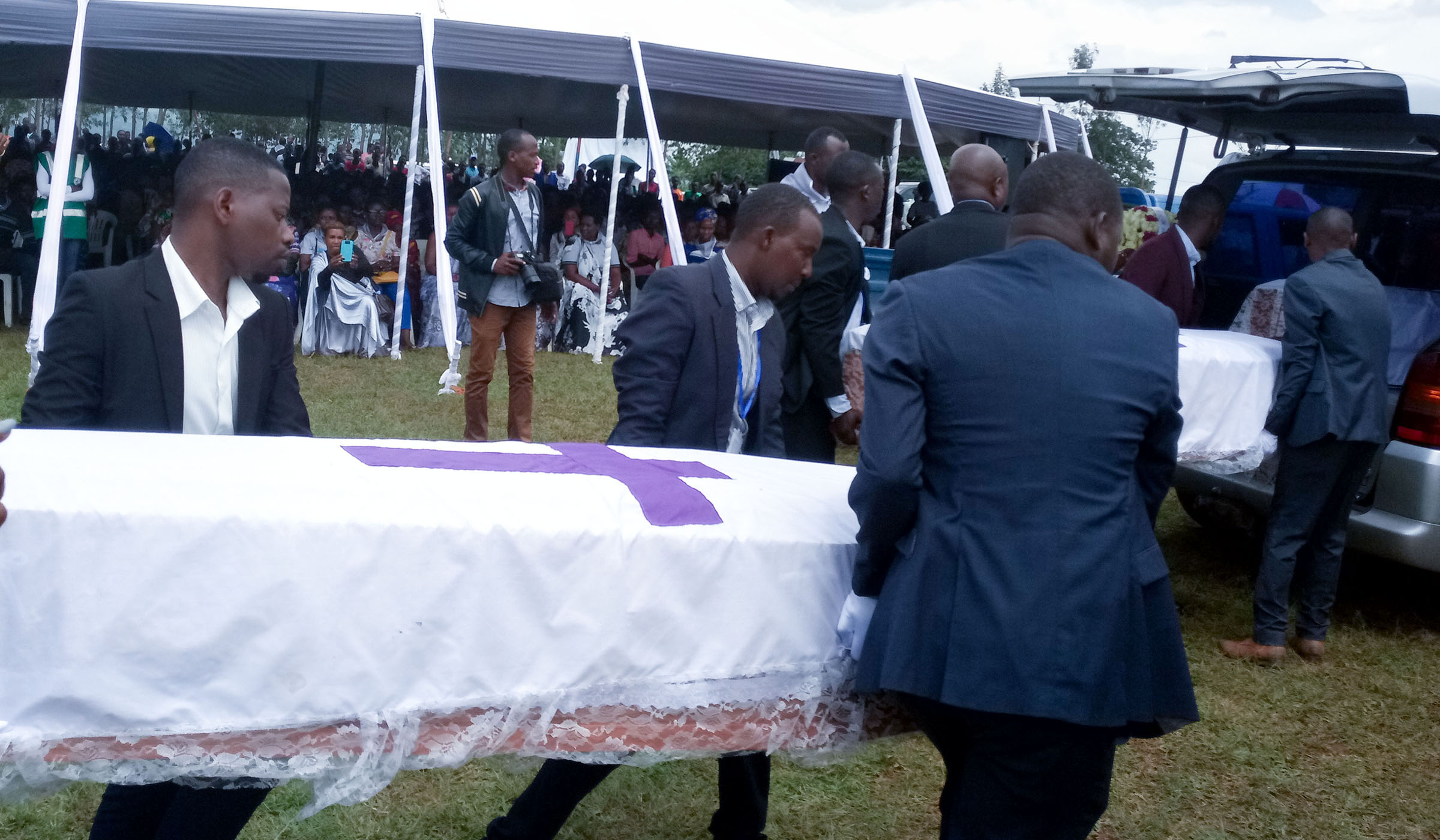 Mourners carry coffins that contain 65 bodies before burial at Ruhanga Genocide Memorial in Gasabo District yesterday. Jean du2019Amour Mbonyinshuti.