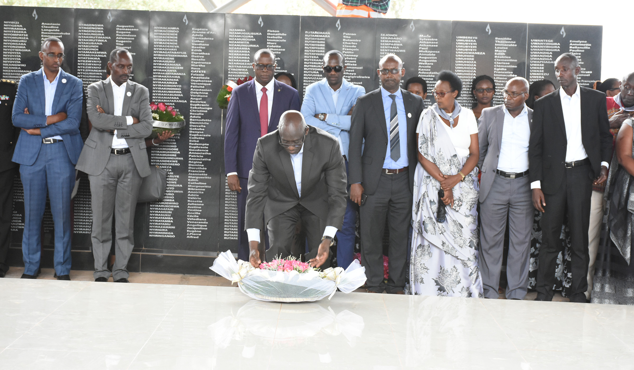 Minister Busingye laying flowers on Ntarama memorial grave, after presiding over the decent burial of 165 victims of Genocide against the Tutsi