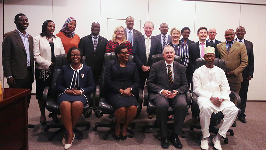 The New Zealand delegation pose with Rwandan members of parliament in a group photo. Sam Ngendahimana.