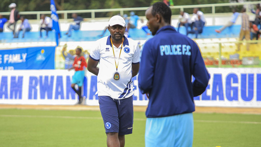 Police FC interim coach Maurice Nshimiyimana speaks to midfielder Mohamed Mushimiyimana during warm-up before they beat Rayon Sports 1-0 at Kigali Stadium last December. Net.