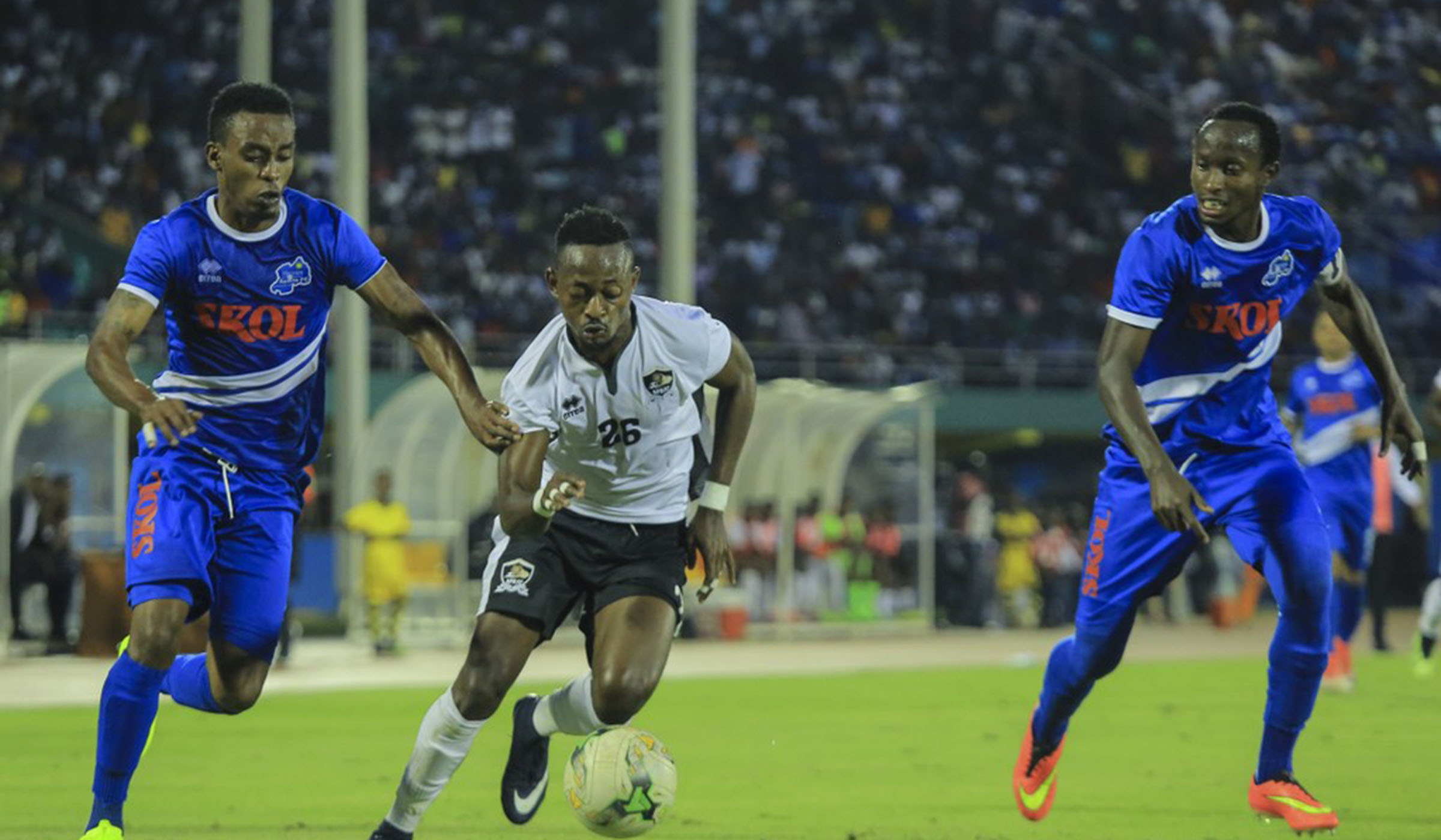 Rayon Sports defenders Eric Rutanga (L) and Thierry Manzi (R) try to challenge APR striker Issa Bigirimana for the ball during a past match between the two sides at Amahoro National Stadium. File