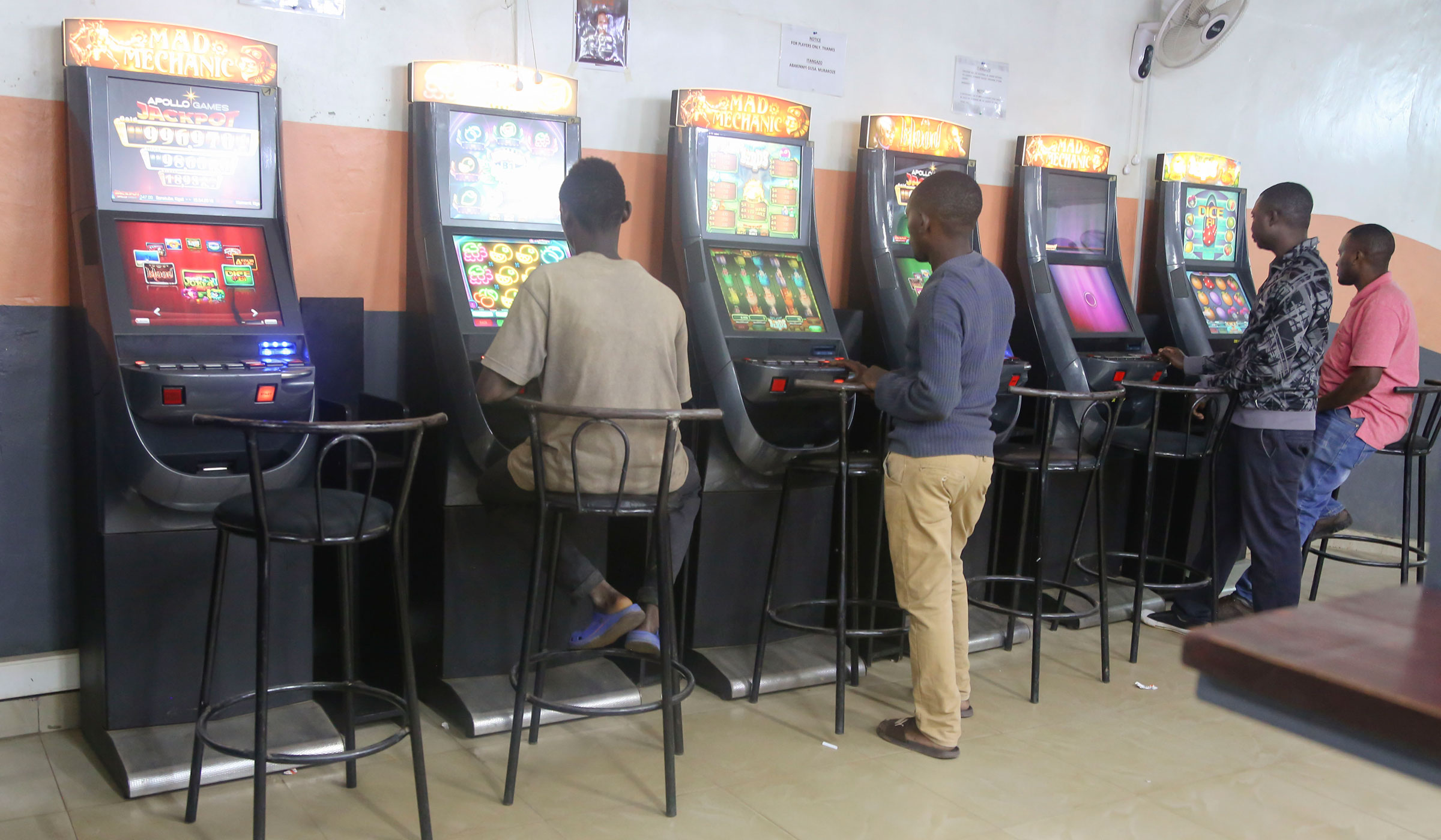 Gamblers play on slot machines at a Fortebet betting shop at Kisimenti in Kigali. Craish Bahizi.