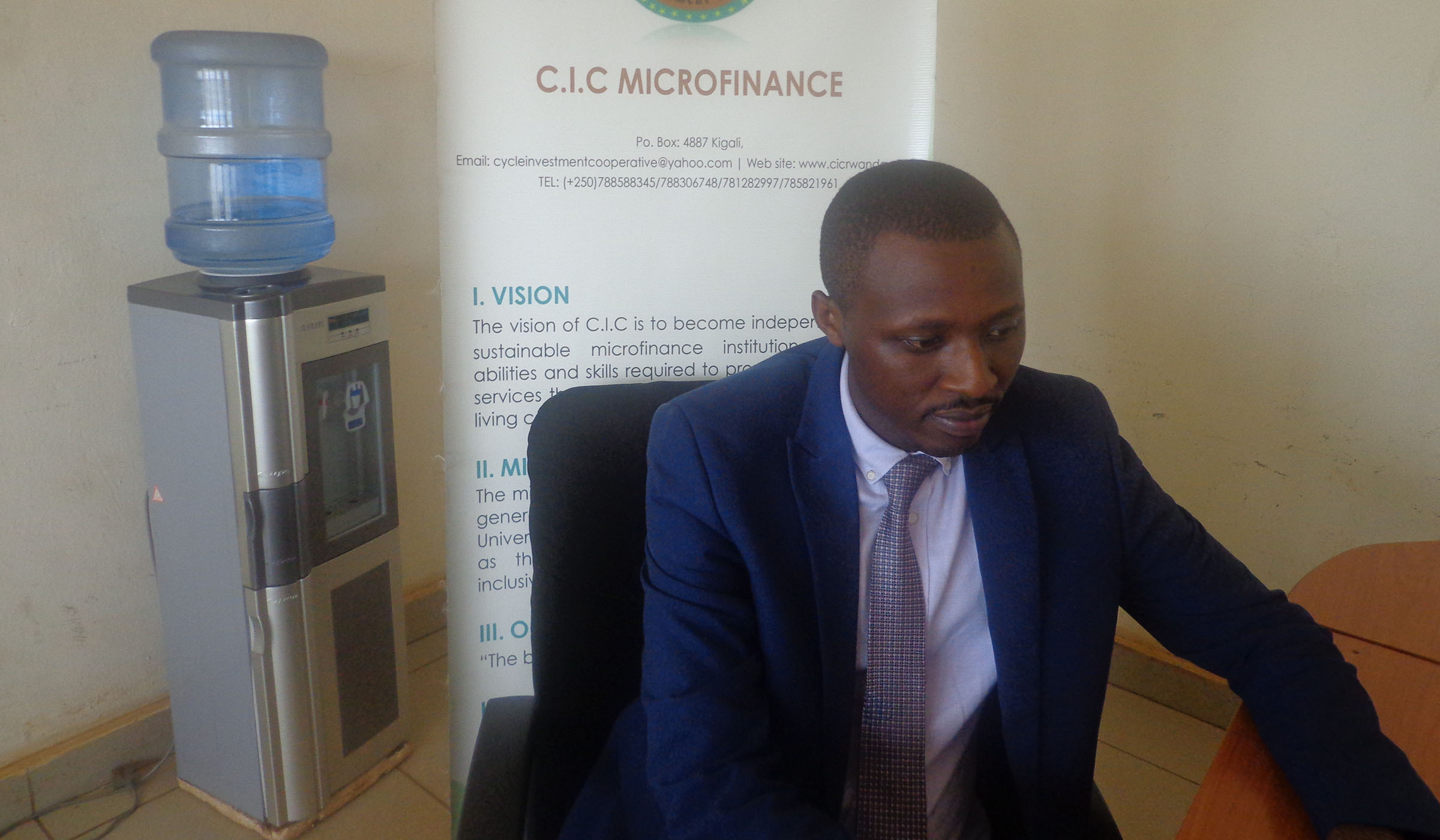 Banamwana in office at the main branch of the microfinance in Gisozi. Simon Peter Kaliisa.