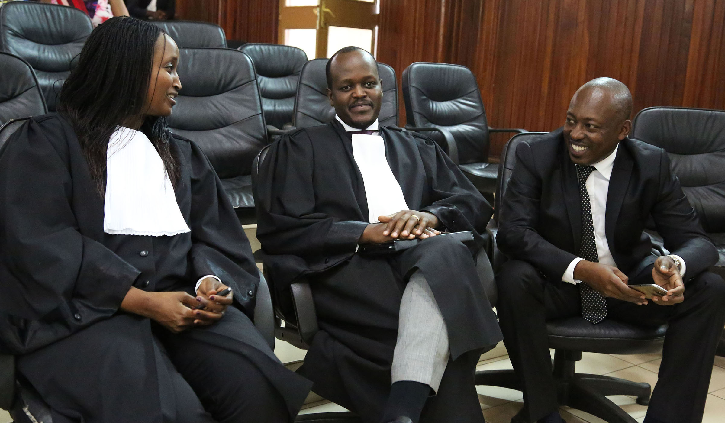 Richard Mugisha (right) consults with his lawyers Moise Nkundabarashi and Florida Kabasinga (left) at the Supreme Court yesterday. Media practitioners have welcomed the decision by the Supreme Court to rule against some provisions in the penal law, which included those that criminalise humiliation of public authorities as well as defamation of religious rituals in the public. Sam Ngendahimana.