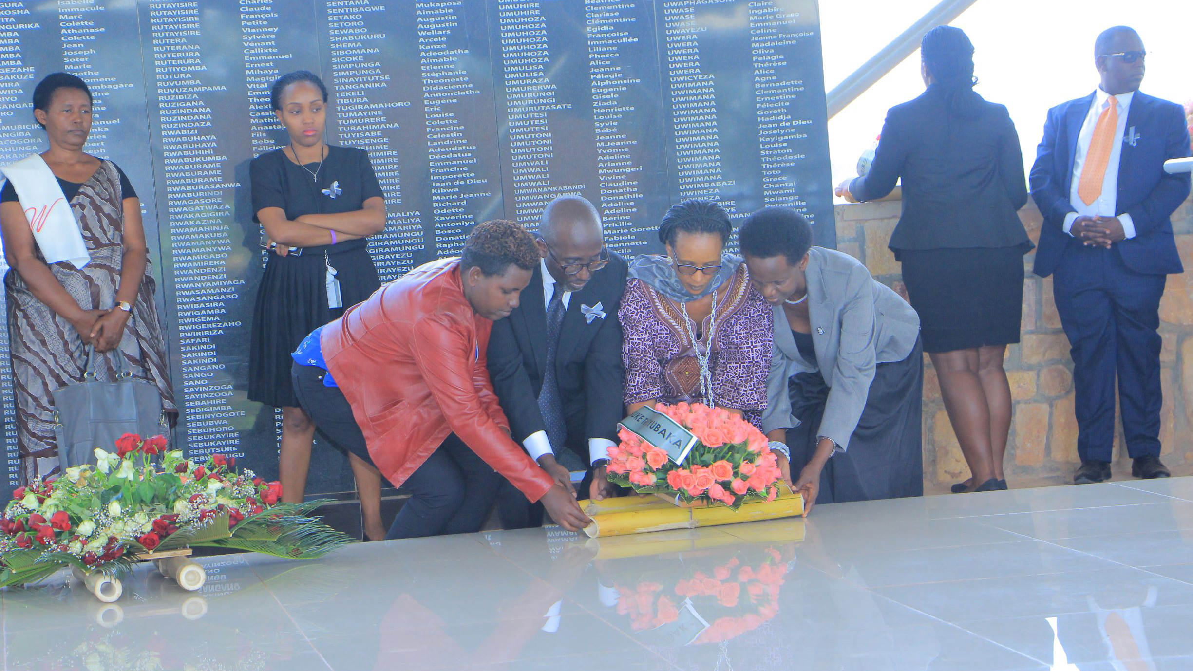 Access Bank Maaging Director Jean Claude Karayenzi  (C) and Valerie Mukabayire of Avega (R) and other officials  honour Tutsi victims laid to rest at Ntarama Genocide Mmeorialu2019s mass grave. Eddie Nsabimana.