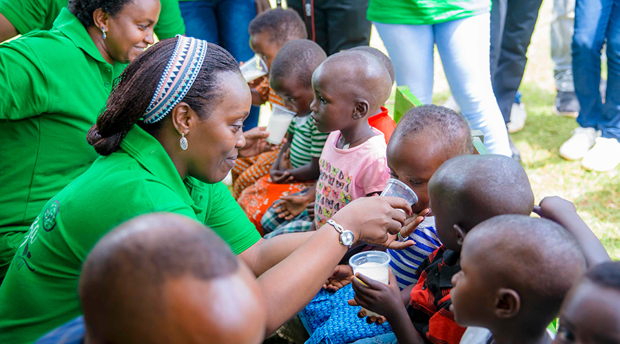 The Minister for health, Dr Diane Gashumba gives milk to children in Nyagatare District on Wednesday. She said that Baho Neza, the Integrated Health Campaign will focus on raising awareness on family planning, and teenage pregnancy prevention. Courtesy.