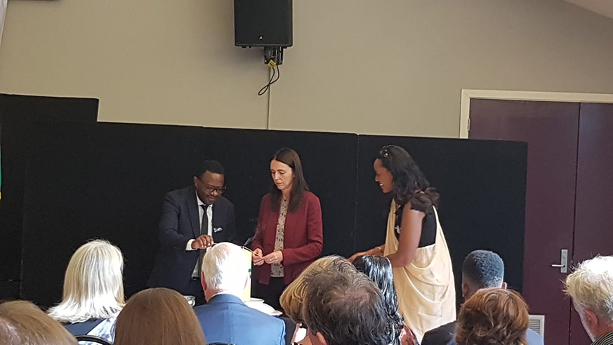 New Zealand Prime Minister Jacinda Ardern lights a candle as members of the Rwandan community and friends of Rwanda commemorate the 1994 genocide against the Tutsi on Saturday. Courtesy.