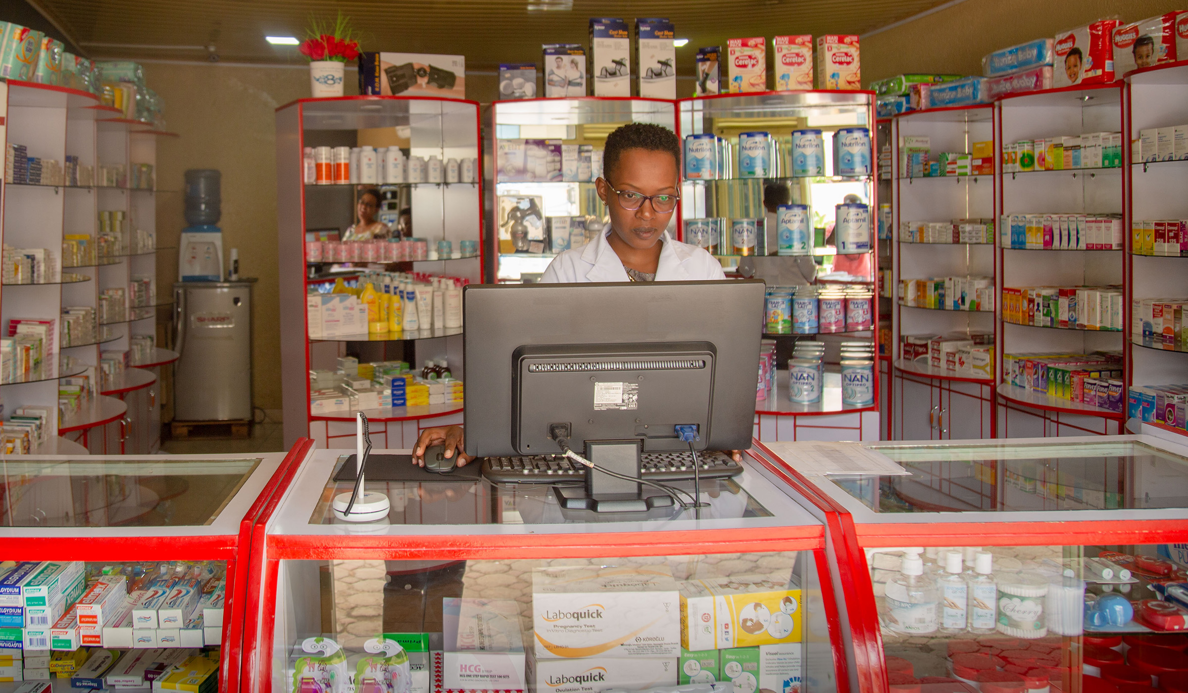 A pharmacist at Unique Pharmacy drugstore in Kigali. Bahizi Craish.
