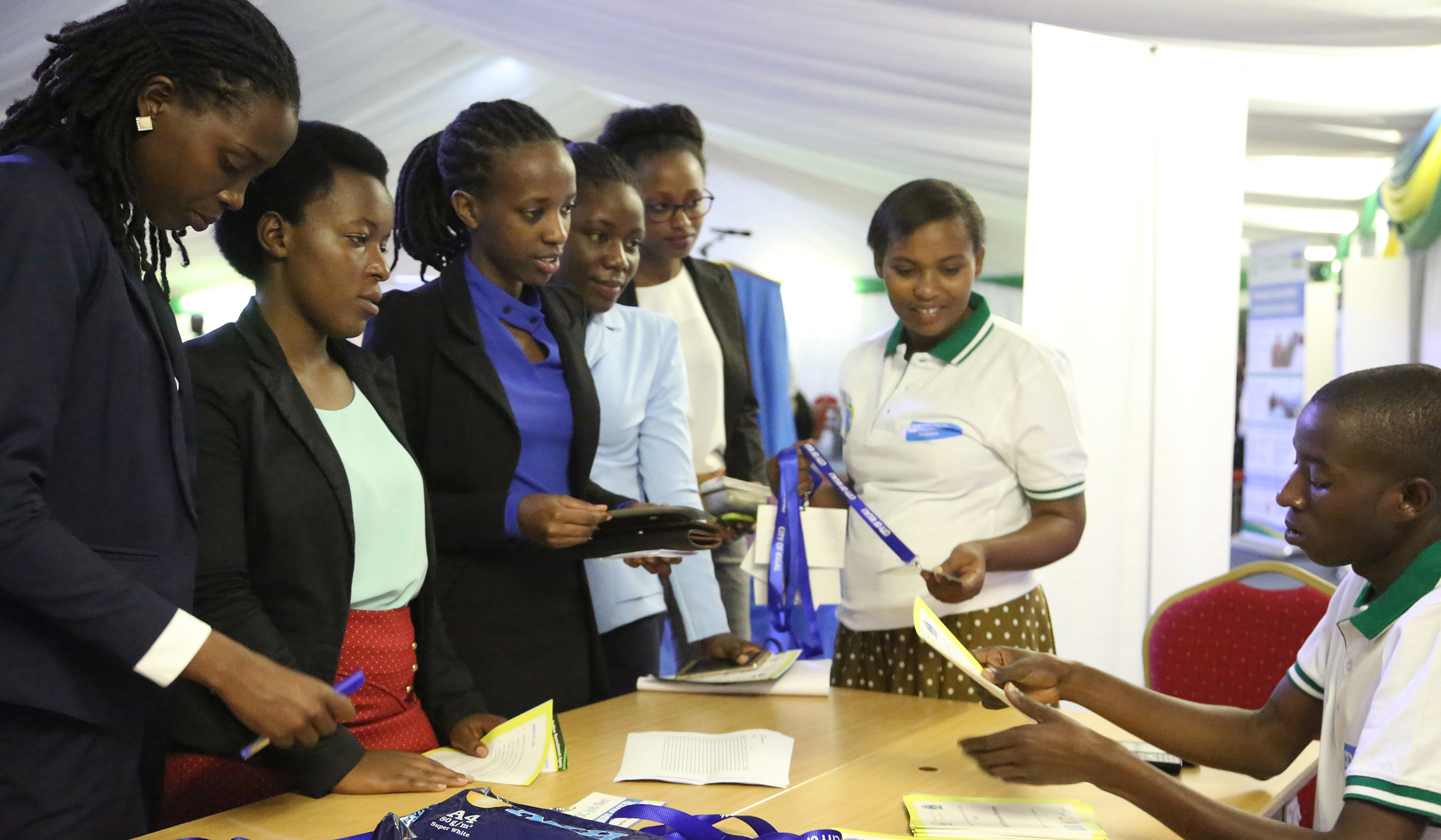 Job seekers interact with a member of staff of the Ministry of Public Service and Labour during Kigali job fair, an event in which job seekers meet with job employers for employment related information or opportunity
