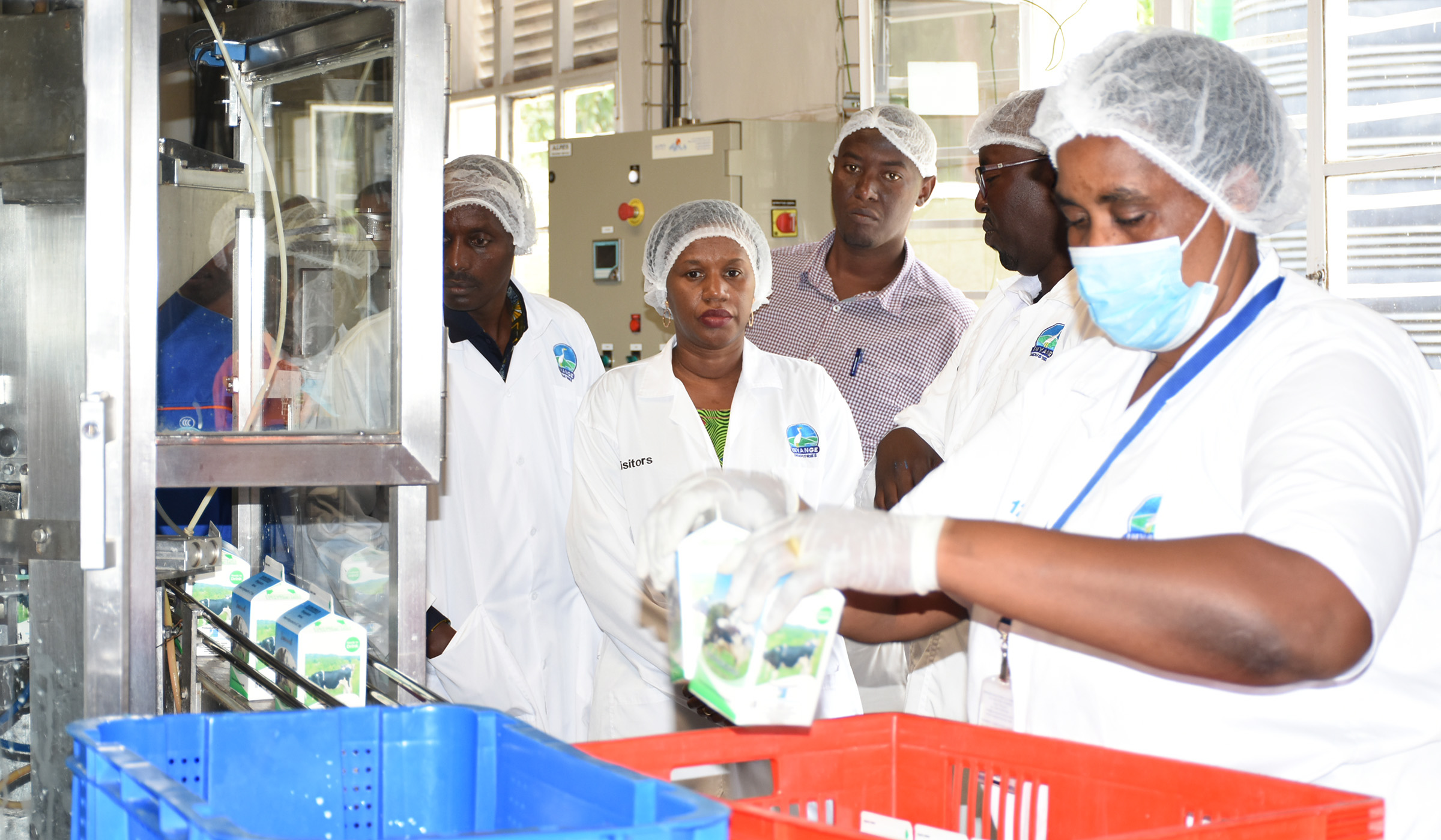 The Minister for Public Service and Labour Fanfan Rwanyindo Kayirangwa (2nd left), Eastern Province Governor Fred Mufulukye (left) and other officials are taken through the process of milk production at Inyange Industries plant in Nyagatare District yesterday. At the national level, Labour Day was marked under the theme: u201cQuality Work, A Catalyst for Sustainable Developmentu201d. Jean de Dieu Nsabimana.