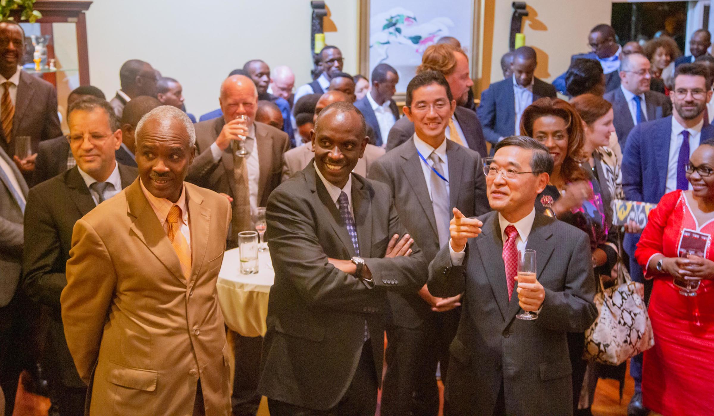 R-L: Amb. Takayuki Miyashita, the Japanese envoy to Rwanda, chats with Foreign  Affairs minister Dr Richard Sezibera, and Amb. Charles Murigande, former Rwandau2019s envoy to Japan, as other guests look on in Kigali on Thursday. Craish Bahizi.