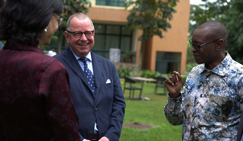 Patrick Nyirishema, the Director-General of Rwanda Utilities Regulatory Authority (right), interacts with the experts from International Atomic Energy Agency after launching the training in Kigali yesterday. Sam Ngendahimana.