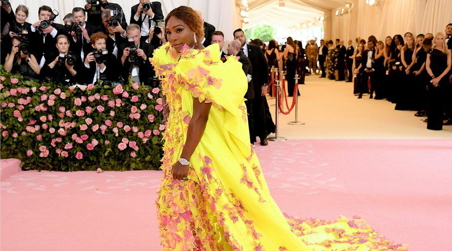 Serena Williams, who is also co-hosting, arrived in a neon yellow gown - with matching Nike trainers. / Net