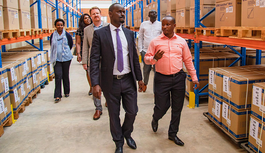 Health ministry Permanent Secretary Jean-Pierre Nyemazi (left) and other officials are given a tour of a new vaccines warehouse at the Special Economic Zone in Kigali, by Hassan Sibomana, the Director of Vaccination Unit at Rwanda Biomedical Centre (right), yesterday. The facility was constructed at a tune of Rwf1.7 billion through a partnership between the Government and Gavi. Emmanuel Kwizera.
