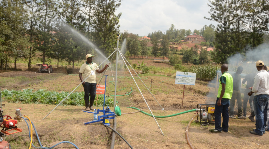Rwanda Agricultural specialist shows some farmers how to carry out irrigation during their study tour at Mulindi recently. / Sam Ngendahimana