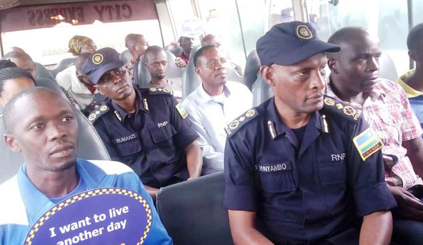 CP George Rumanzi (2nd row), and CP Bruce Munyambo listen as a bus driver gives road safety tips to passengers. Courtesy.