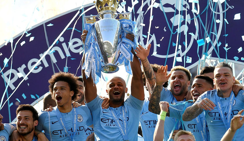 Captain Vincent Kompany lifts the Premier League trophy as he and teammates celebrate Manchester City's back-to-back win of the silverware, having beaten Liverpool to the highly coveted crown by a solitary point on the final day of the season on Sunday. Net