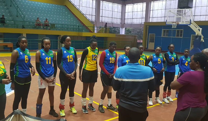 The national team players listen to coaching staff before starting their afternoon training at Petit Stadium on Tuesday. Yvonne Iradukunda.