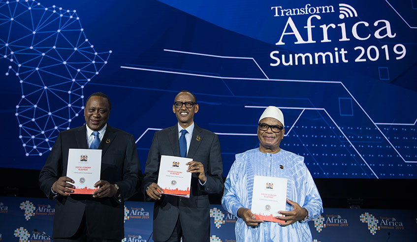 President Paul Kagame, and his counterparts Uhuru Kenyatta of Kenya (left), and Ibrahim Boubacar Keu00efta of Mali pose with copies of Kenyan governmentu2019s u2018Digital Economy Blueprintu2019 on the first day of the 5th Transform Africa Summit in Kigali yesterday. Village Urugwiro.