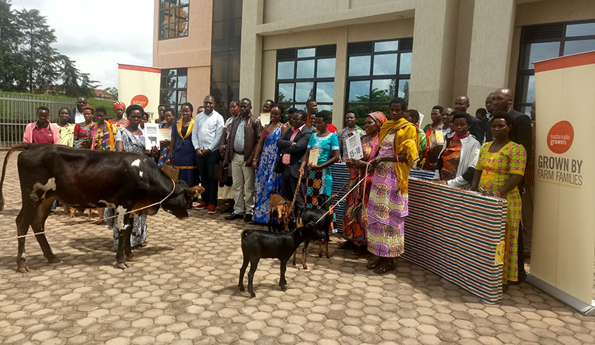 Some awarded women farmers pose in a group photo with officials from Sustainable Growers, and districts after the graduation ceremony, Wednesday, May 15, 2019 (Emmanuel Ntirenganya)