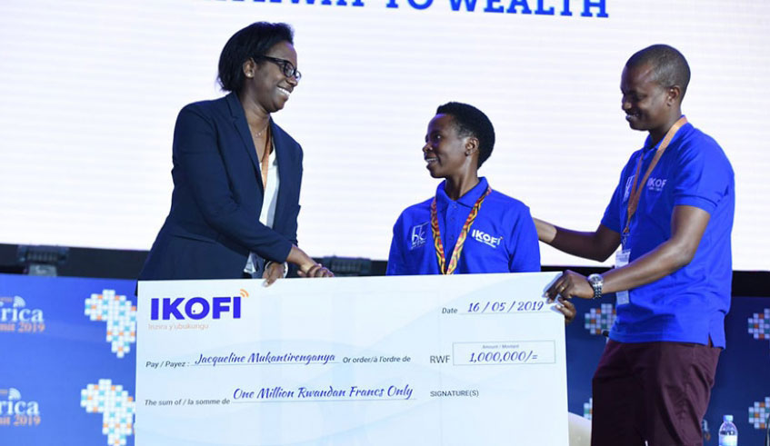 Bank of Kigali will also be awarding a client on the platform every week. The first farmer to win Rwf1 million in the  u201cOne million per week Campaignu201d, Jacqueline Mukantirenganye, receives a dummy cheque  from BK CEO Diane Karusisi. Courtesy.