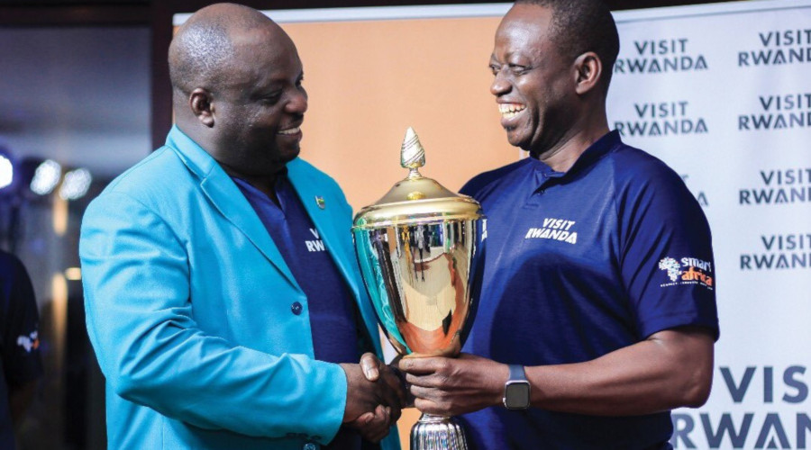Davis Kashaka (L) receives the trophy after dominating the one-day event at Kigali Golf Club on Friday. / Courtesy