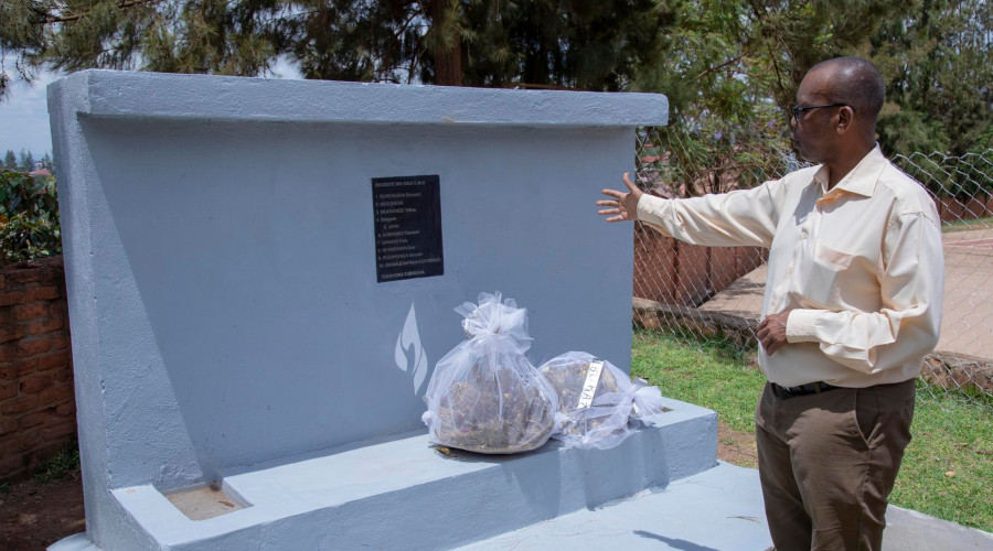 Damas Gisimba Mutezintare, the Director of the Gisimba Memorial Centre shows a plaque with names of 18 victims killed during the Genocide. / Emmanuel Kwizera