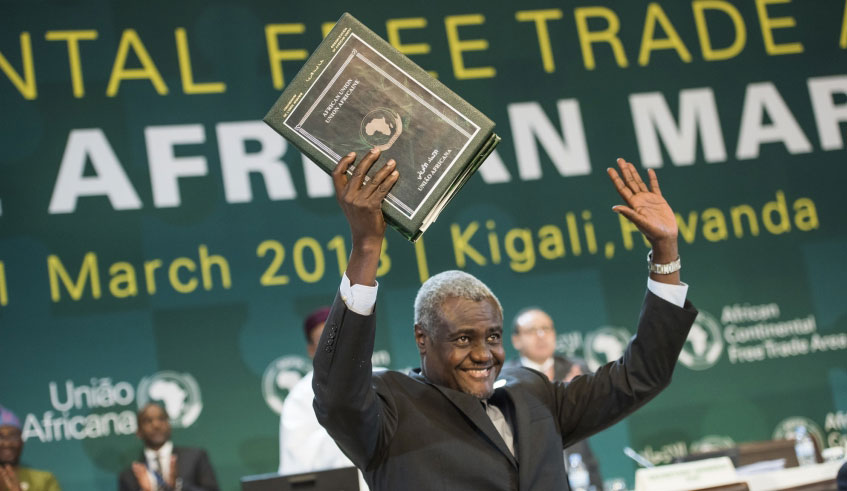 AU Commission Chairperson Moussa Faki Mahamat presents a copy of AfCFTA deal at the African Union Summit in Kigali in March 2018. File.