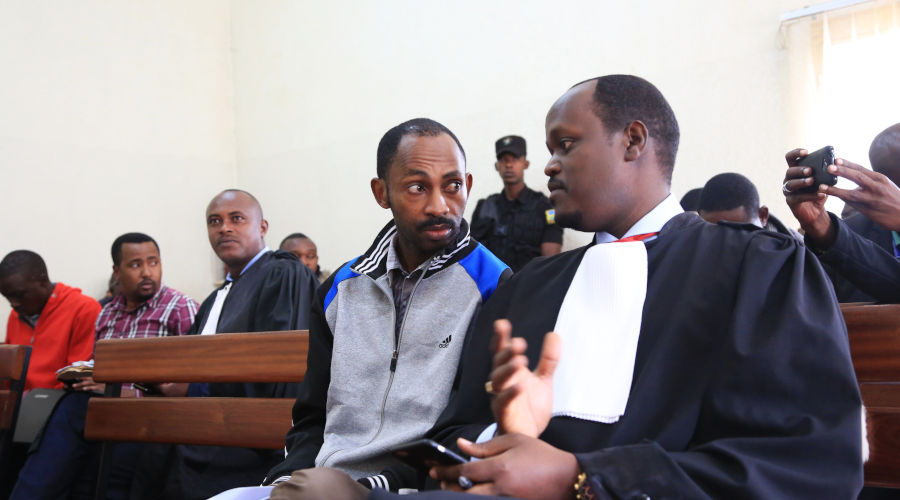 Nsabimana (left) consults his lawyer Moise Nkundabarashi in court yesterday. / Sam Ngendahimana