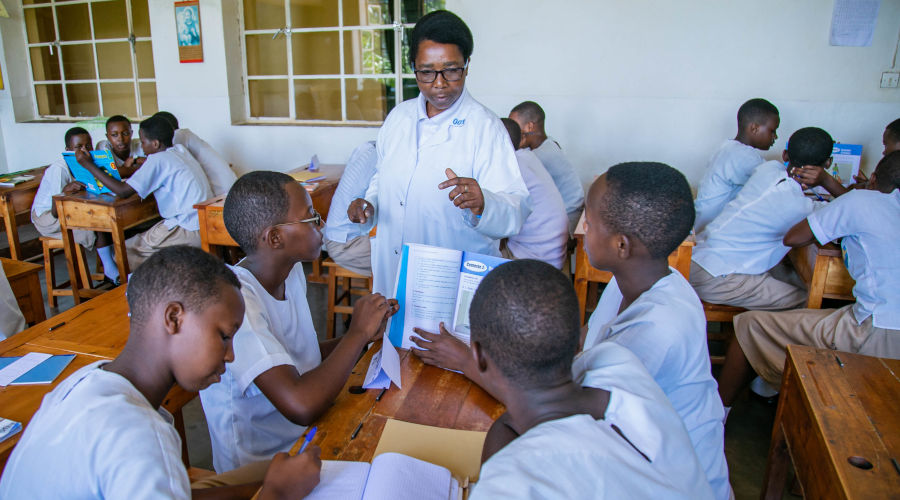 Students of Institut Sainte Famille de Nyamasheke in classroom with their female teacher. / Emmanuel Kwizera