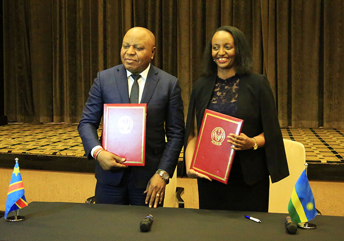 Minister for Trade and Industry, Soraya Hakuziyaremye (R) and Lambert Matuku Memas, the Congolese Minister for External Trade pose for photos after signing the agreement. (Sam Ngendahimana)