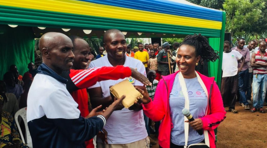 Kigali Marriott Hotelu2019s Senior Human Resource Manager Nicole Ingabire hands over an envelope of money to the executive head of Nyarugenge District and other leaders. / James Peter Nkurunziza