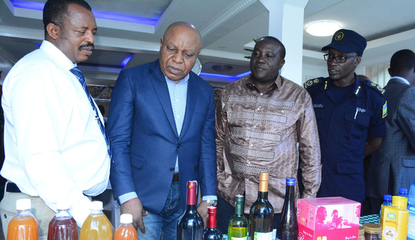 The Congolese Minister for External Trade Matuku (2nd-L) inspecting juices and wine that are manufactured at Urwibutso Enterprise. He called on producers to export products to DR Congo. Ru00e9gis Umurengezi.