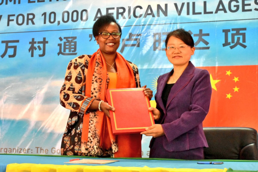 Xing Yuchun(R), the Charge d'Affaires of the Chinese Embassy in Rwanda, handover the satellite TV project documents to Local Government Permanent Secretary Assoumpta Ingabire, after the signing. / Eddie Nsabimana