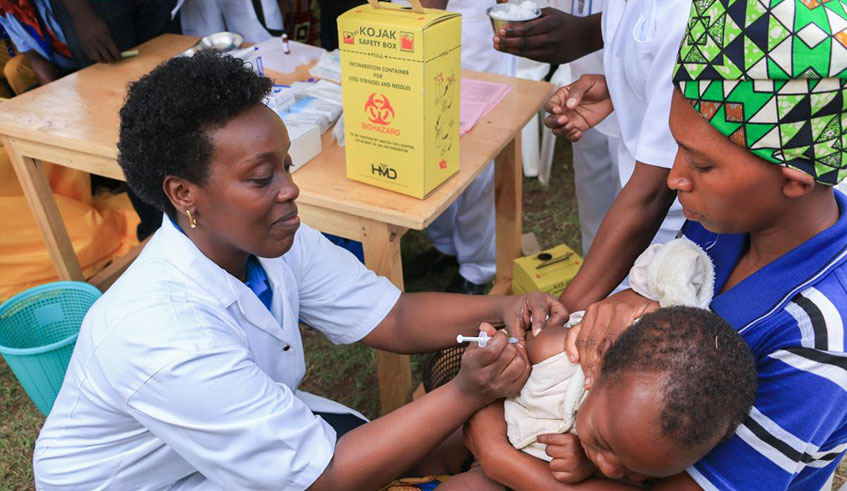 Health Minister Dr Diane Gashumba vaccinates a child against measles and rubella in 2017. The country reduced under-5 mortality by 79 per cent since 2000, making it the biggest mover of change in improving childrenu2019s lives in the region. Courtesy.
