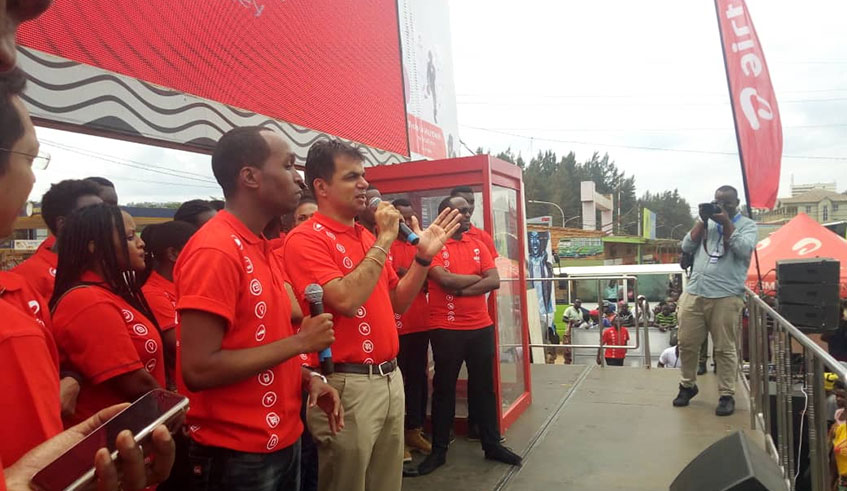 Airtel Managing Director, flanked by other staff members, addresses a crowd during the launch of the Airtel campaign. James Peter Nkurunziza.