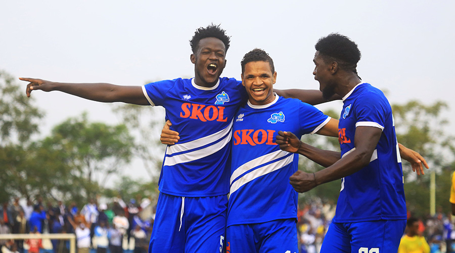 Ange Mutsinzi (L) celebrates with teammates Rafael Jonathan da Silva (C) and Hussein Habimana after scoring the injury time goal to put Rayon Sports into the commanding position into commanding position of the two-legged tie against AS Kigali on Tuesday. / Sam Ngendahimana