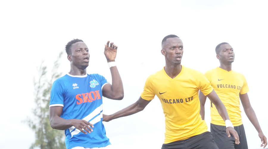 Said Iragire (C) marks Rayon Sports striker Michael Sarpong (L) during a past league match at Huye Stadium. / Courtesy