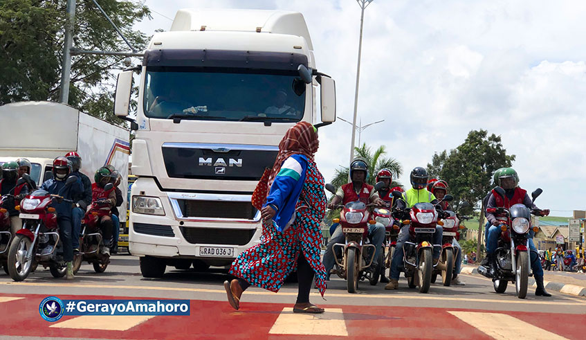 A pedestrian crosses a road as motorists look on during the ongoing u2018Gerayo amahorou2019 road safety campaign. Courtesy.