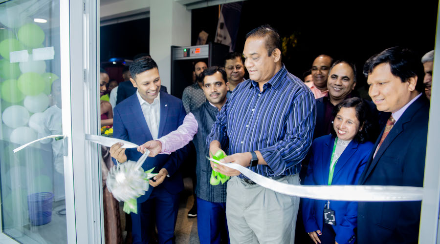 Indian High Commissioner to Rwanda, Amb. Oscar Kerketta (centre) cuts a tape during the official opening of the new showroom at Kigali Business Centre in Kacyiru. / Simon Peter Kaliisa