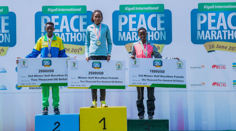 Marthe Yankurije (left) finished behind the winner, Celestine Chepchirichir of Kenya, in the womenu2019s half-marathon category at this yearu2019s Kigali Peace Marathon yesterday. Right is Kenyan Martha Akeno, who finished third in this particular race. / Emmanuel Kwizera