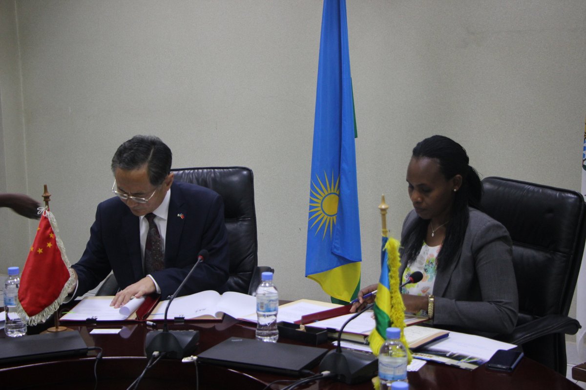 Chinese envoy to Rwanda Rao Hongwei and the State Minister for Economic Planning, Claudine Uwera, sign the deal in Kigali on Tuesday. / Courtesy