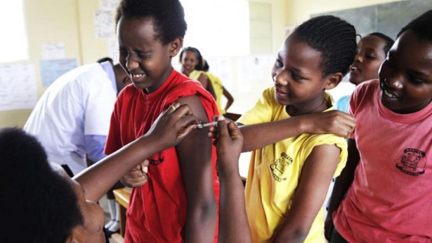 A nurse at Kagugu Health Centre immunises primary school pupils. / Sam Ngendahimana