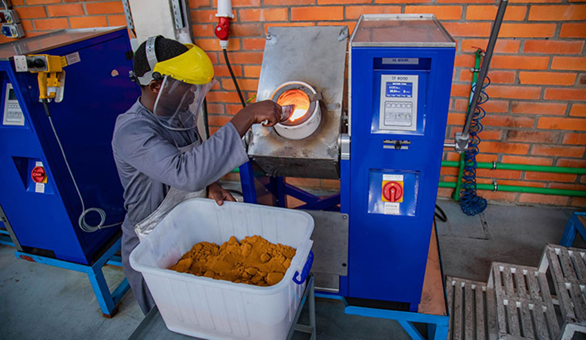 A worker at Aldango Gold Refinery puts gold powder into a high temperature heating device to melt. Emmanuel Kwizera.