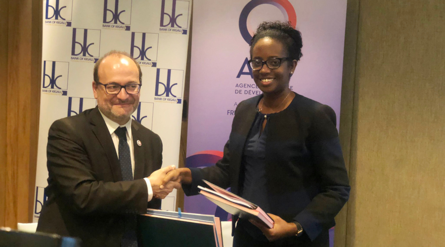 The Director General of the French Development Agency, Remy Rioux, and Bank of Kigali chief executive Diane Karusisi exchange documents after signing the agreement  in Kigali yesterday. / Courtesy