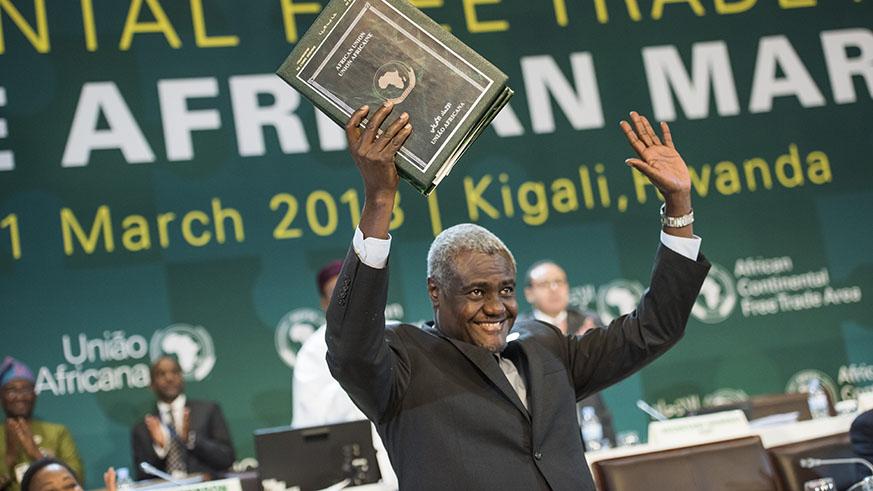 The Chairperson of the African Union Commission Moussa Faki Mahamat holds the instruments after they were signed by the heads of state and representatives from various African countries in Kigali. (File)