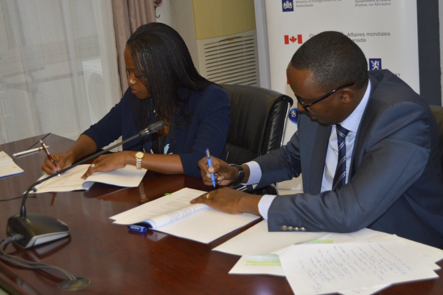 Michel Minega Sebera (R), Permanent Secretary at the ministry of trade and Country Manager, TradeMark East Africa (TMEA), Patience Mutesi sign the agreement. (Courtesy)