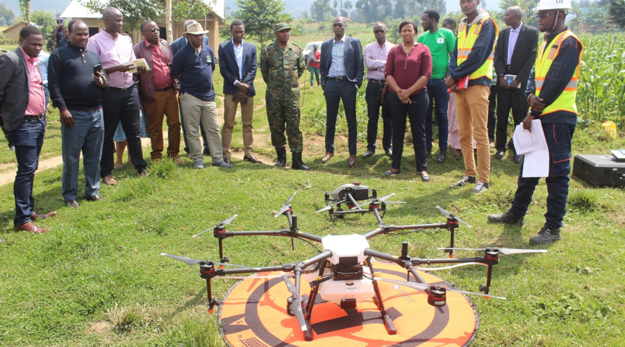 Musanze farmers, local officials and partners observe drones before take-off on a mission to collect data from fields and to spray liquid pesticides on farms, last week. Towards the end of last year, Charis Unmanned Aerial Solutions, a company that was started by young Rwandan nationals, conducted an exercise to demonstrate the potential of drones in driving agriculture output in Gataraga Sector in Musanze District. / Ru00e9gis Umurengezi